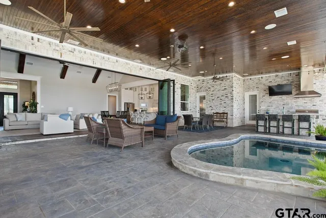 a swimming pool with outdoor seating and outdoor view