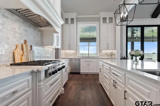 a kitchen with stainless steel appliances granite countertop a stove and a sink