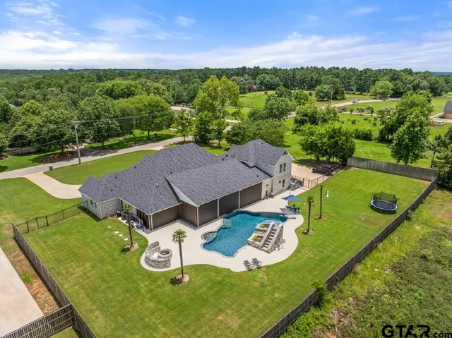 an aerial view of a house with pool