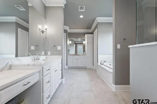 a spacious bathroom with a double vanity sink and a mirror