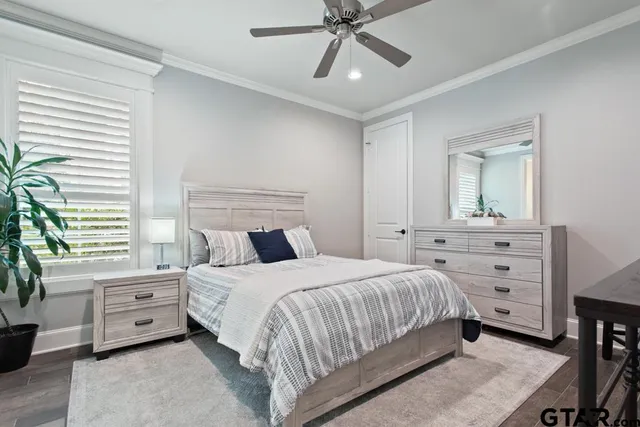 a en suite bathroom with a granite countertop sink and a mirror