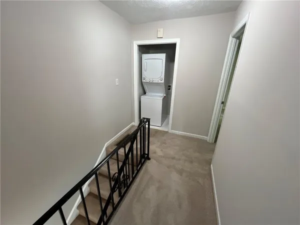 a view of a hallway with wooden floor and entryway