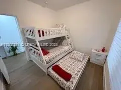 a bed sitting in a bedroom next to a window