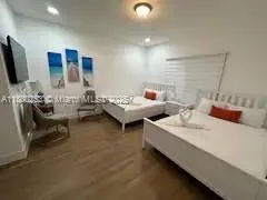 a bedroom with two beds and a television