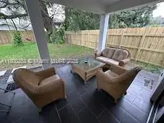 a outdoor living space with furniture and a potted plant