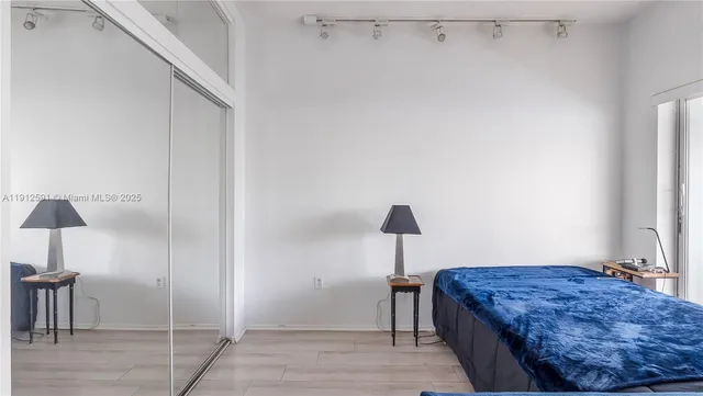 a bedroom with a bed and a lamp on table