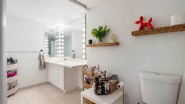 a bathroom with a sink a mirror and a toilet