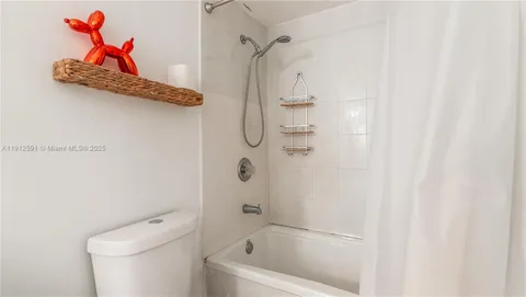 a bathroom with a shower a toilet and a shower