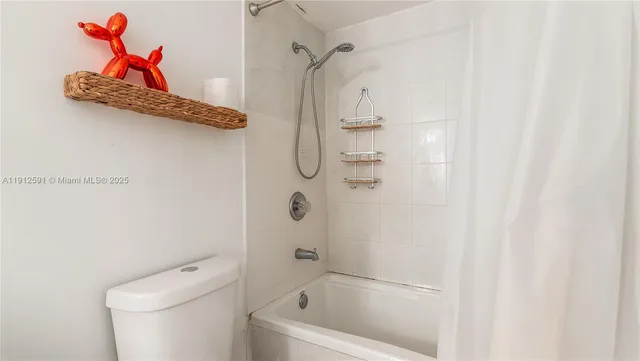 a bathroom with a shower a toilet and a shower