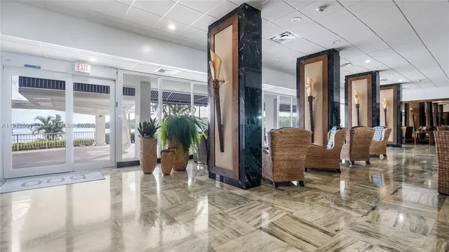 a lobby with furniture and floor to ceiling window