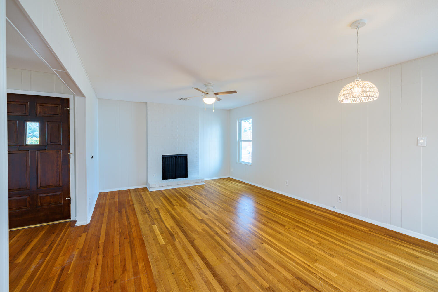 1400 Ruth Avenue Austin, TX 78757 - Photo 9 of 29 Gleaming hardwood floors and a brick fireplace anchor this versatile living space.