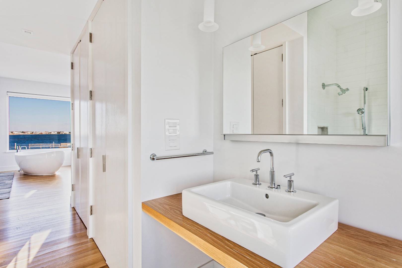 346 Dune Road Westhampton Beach, NY 11978 - Photo 7 of 13 a bathroom with a sink and a mirror