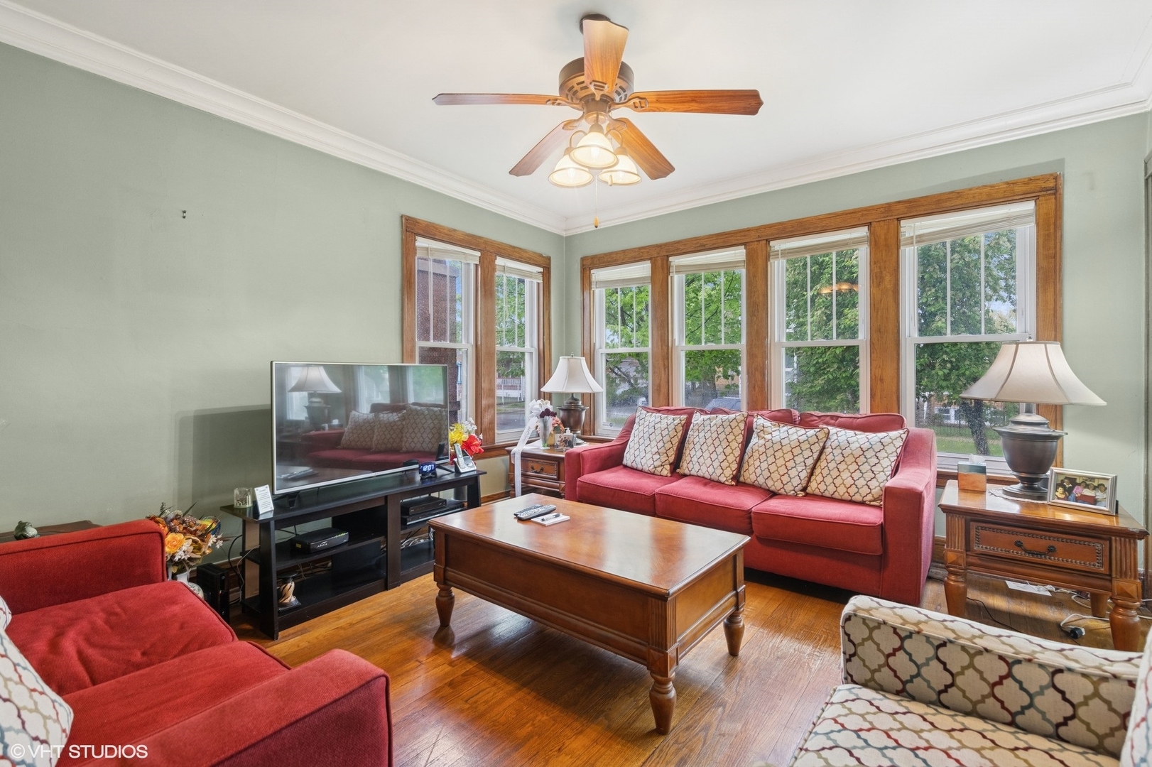 4904 West Deming Place Chicago, IL 60639 - Photo 3 of 15 a living room with furniture a flat screen tv and a floor to ceiling window
