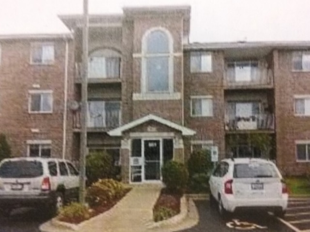 881 Swift Road, Unit 202 Addison, IL 60101 - Photo 1 of 6 a front view of a house with parking space