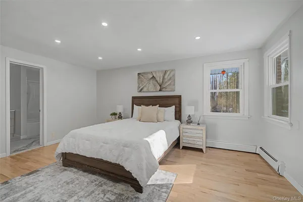 a bedroom with a large bed and a window