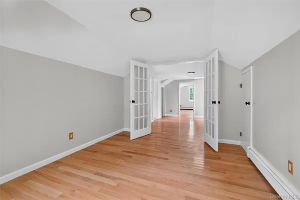 a view of a room with wooden floor and white walls