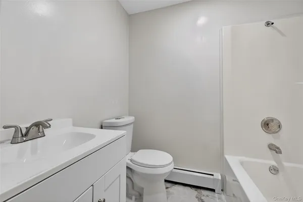 a white toilet sitting next to a bathroom sink