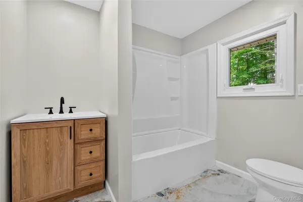 a bathroom with a sink a toilet and bathtub
