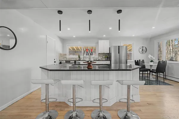 a large kitchen with a table and chairs