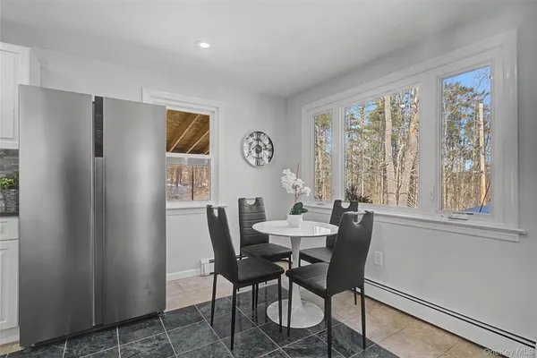 a view of a dining room with furniture window and outside view