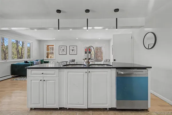 a large kitchen with stainless steel appliances granite countertop a sink and cabinets
