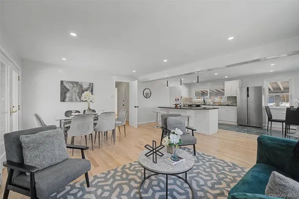 a living room with furniture and view of kitchen