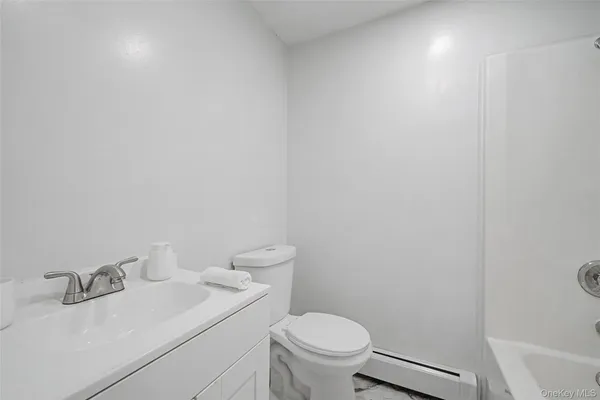 a bathroom with a sink a toilet and vanity