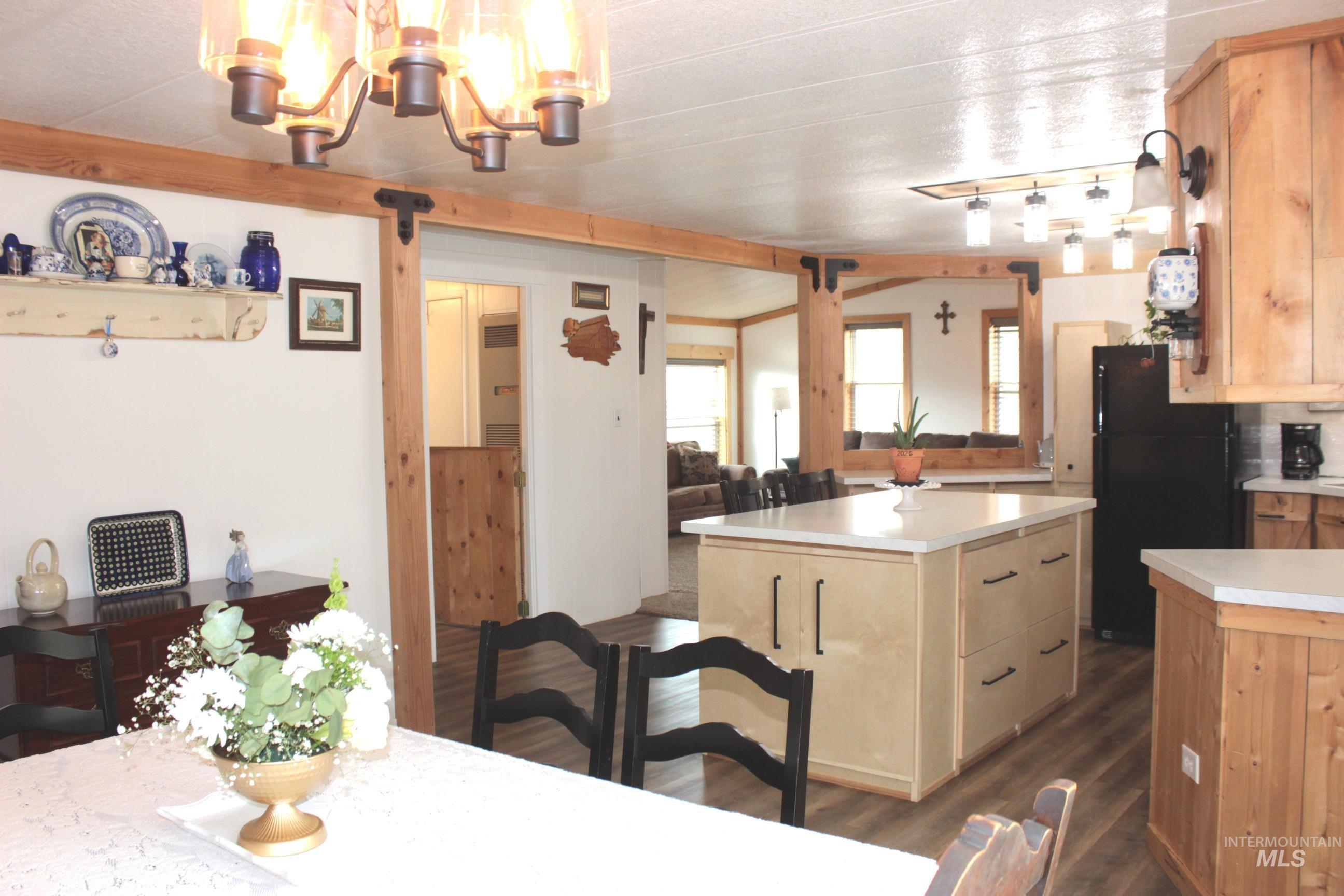 1824 Dutch Flat Road Midvale, ID 83645 - Photo 41 of 41 Kitchen with freestanding refrigerator, a kitchen island, light countertops, dark wood-style flooring, and open floor plan