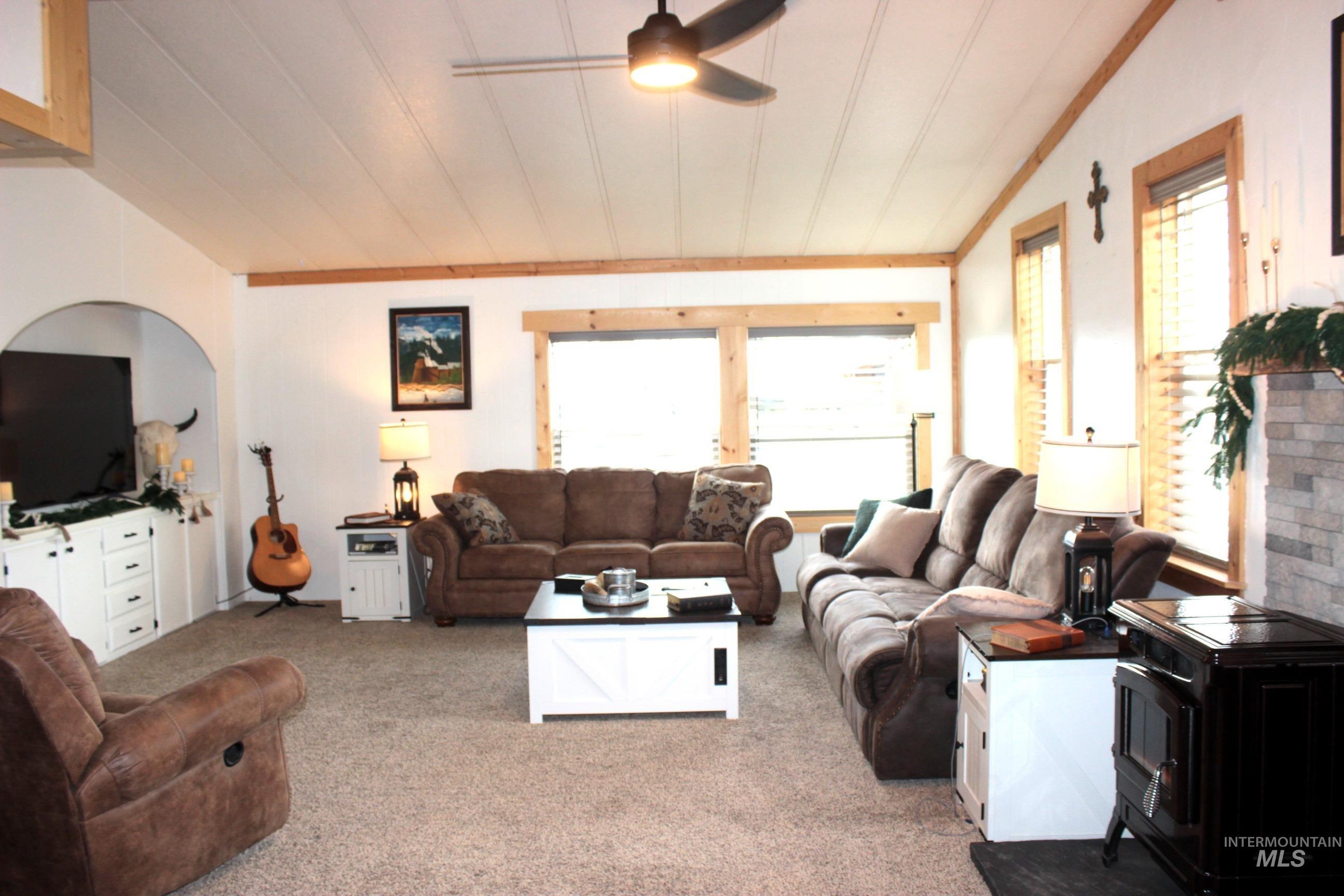 1824 Dutch Flat Road Midvale, ID 83645 - Photo 8 of 41 Living room with vaulted ceiling, ceiling fan, plenty of natural light, light colored carpet, and ornamental molding