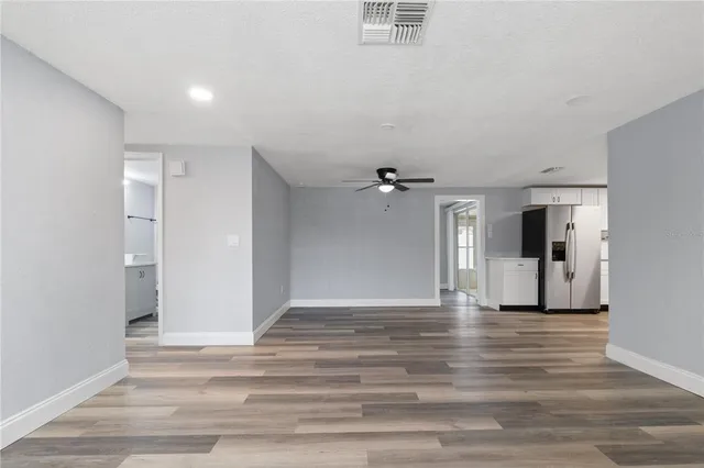 a spacious bathroom with a toilet a sink and a mirror