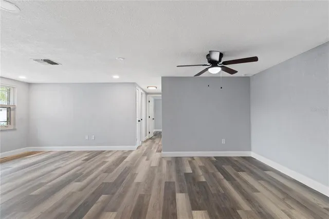 a view of empty room with ceiling fan
