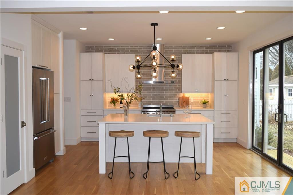13 Cherokee Road Cranford, NJ 07016 - Photo 12 of 25 a kitchen with stainless steel appliances kitchen island granite countertop a refrigerator and a stove top oven