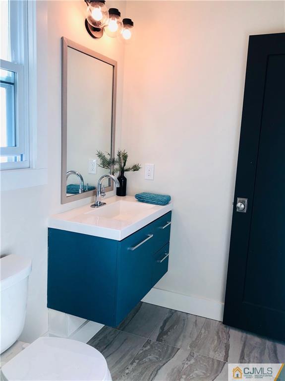 13 Cherokee Road Cranford, NJ 07016 - Photo 16 of 25 a bathroom with a sink and a mirror
