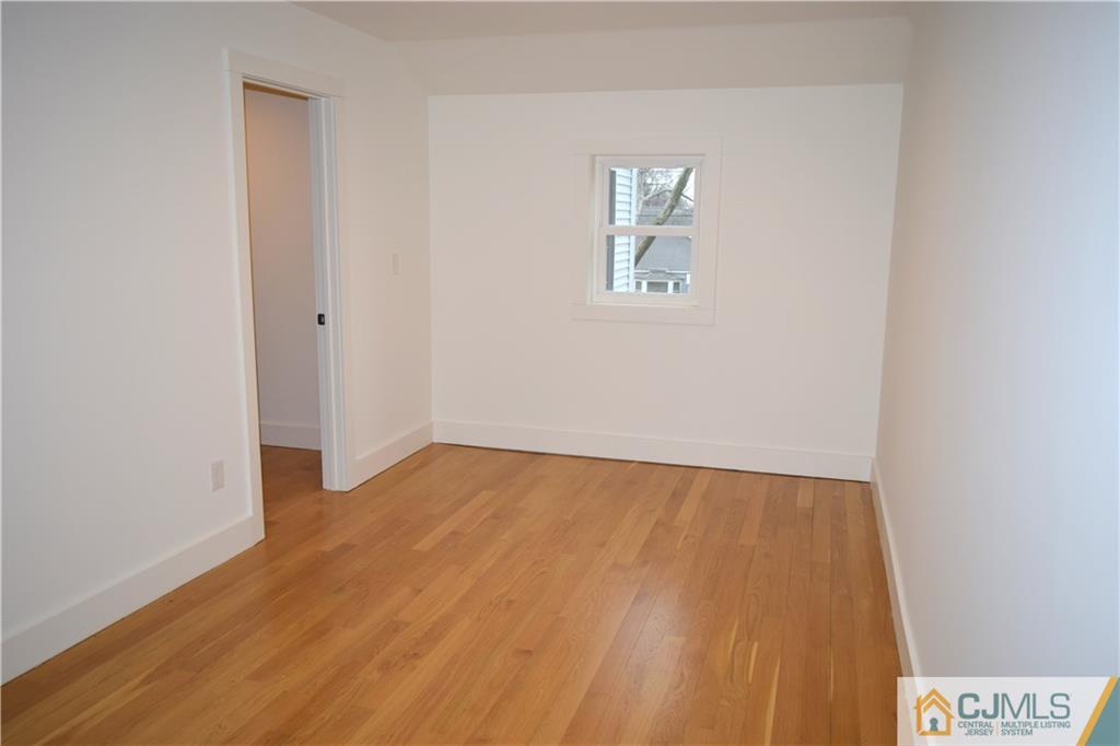 13 Cherokee Road Cranford, NJ 07016 - Photo 24 of 25 a view of an empty room with wooden floor and a window