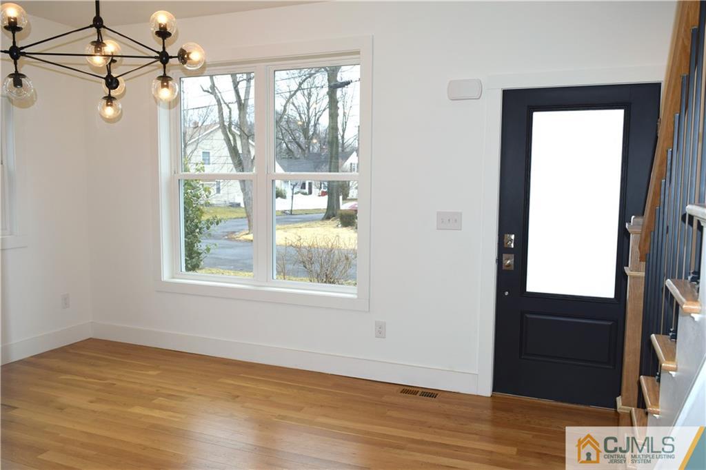 13 Cherokee Road Cranford, NJ 07016 - Photo 4 of 25 an empty room with wooden floor and windows
