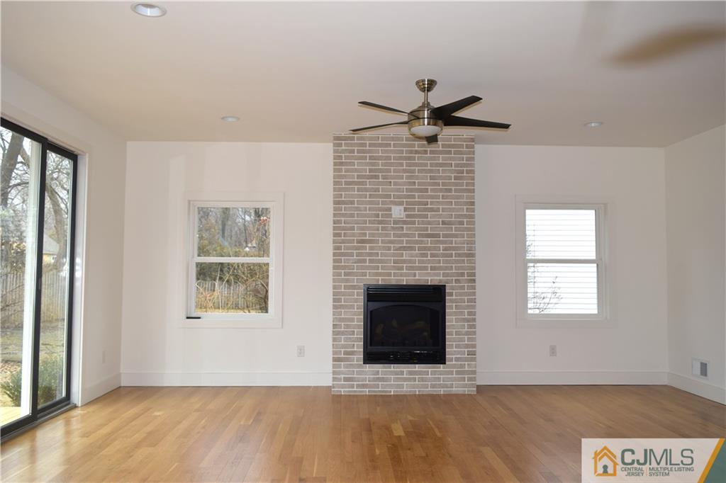 13 Cherokee Road Cranford, NJ 07016 - Photo 5 of 25 an empty room with windows and fireplace