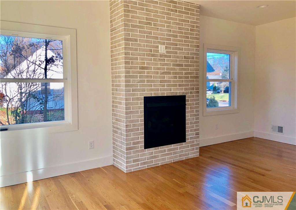 13 Cherokee Road Cranford, NJ 07016 - Photo 6 of 25 a view of an empty room with wooden floor and a window