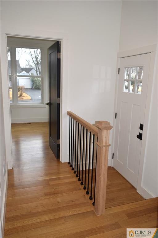 13 Cherokee Road Cranford, NJ 07016 - Photo 7 of 25 a view of a hallway with wooden floor and a living room