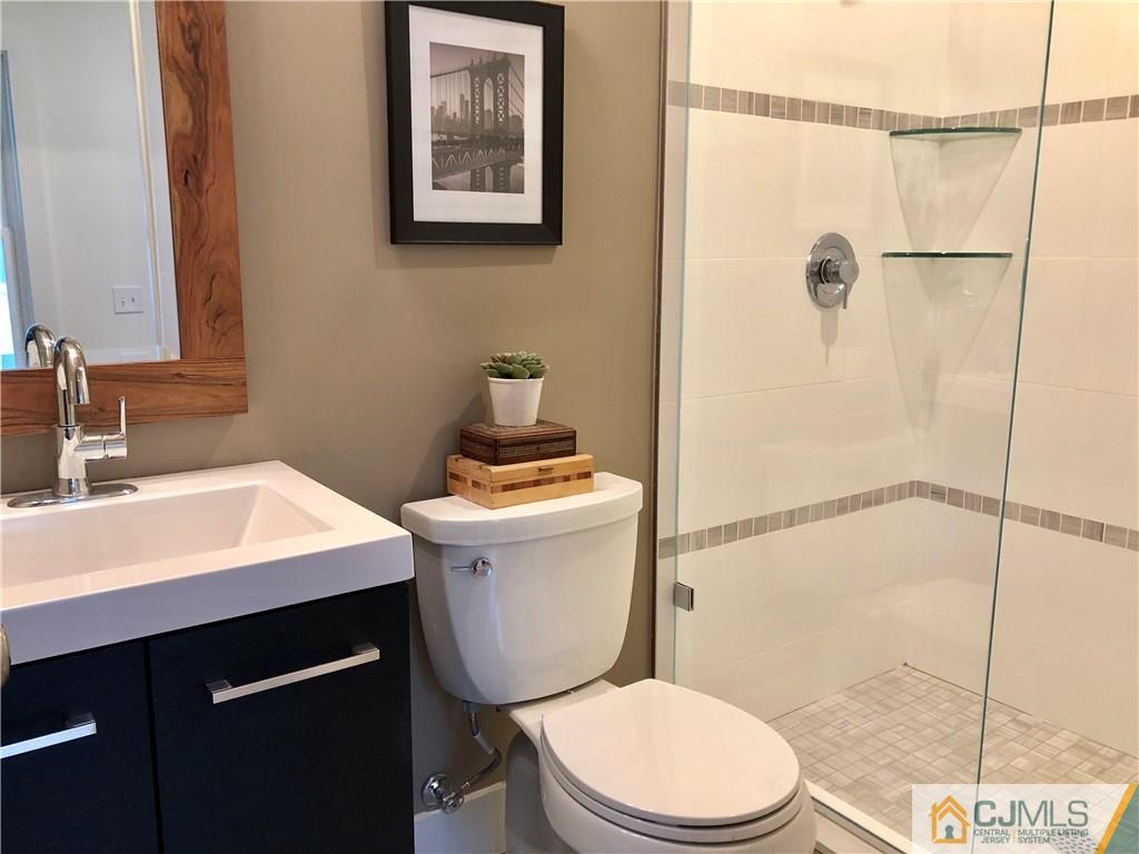 13 Cherokee Road Cranford, NJ 07016 - Photo 10 of 25 a bathroom with a sink a toilet and shower