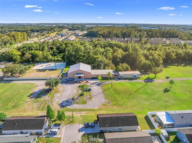 an aerial view of residential houses with outdoor space and swimming pool