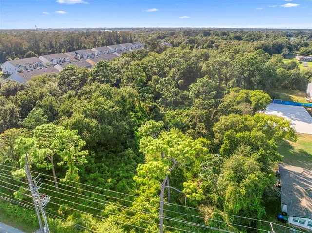 a view of a green field with lots of bushes