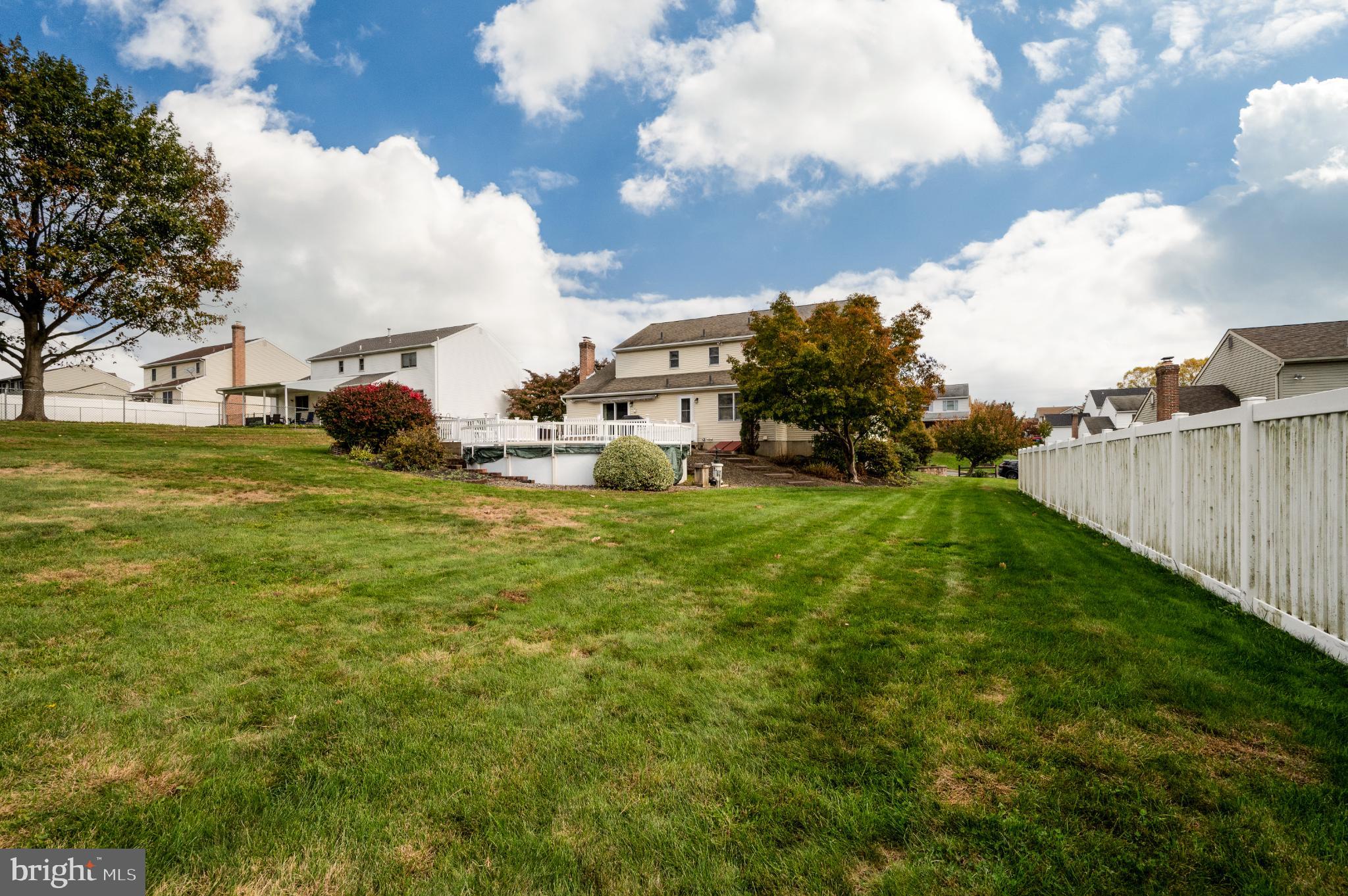 1052 Boeshore Circle Reading, PA 19605 - Photo 18 of 72 Spacious backyard with vibrant greenery.