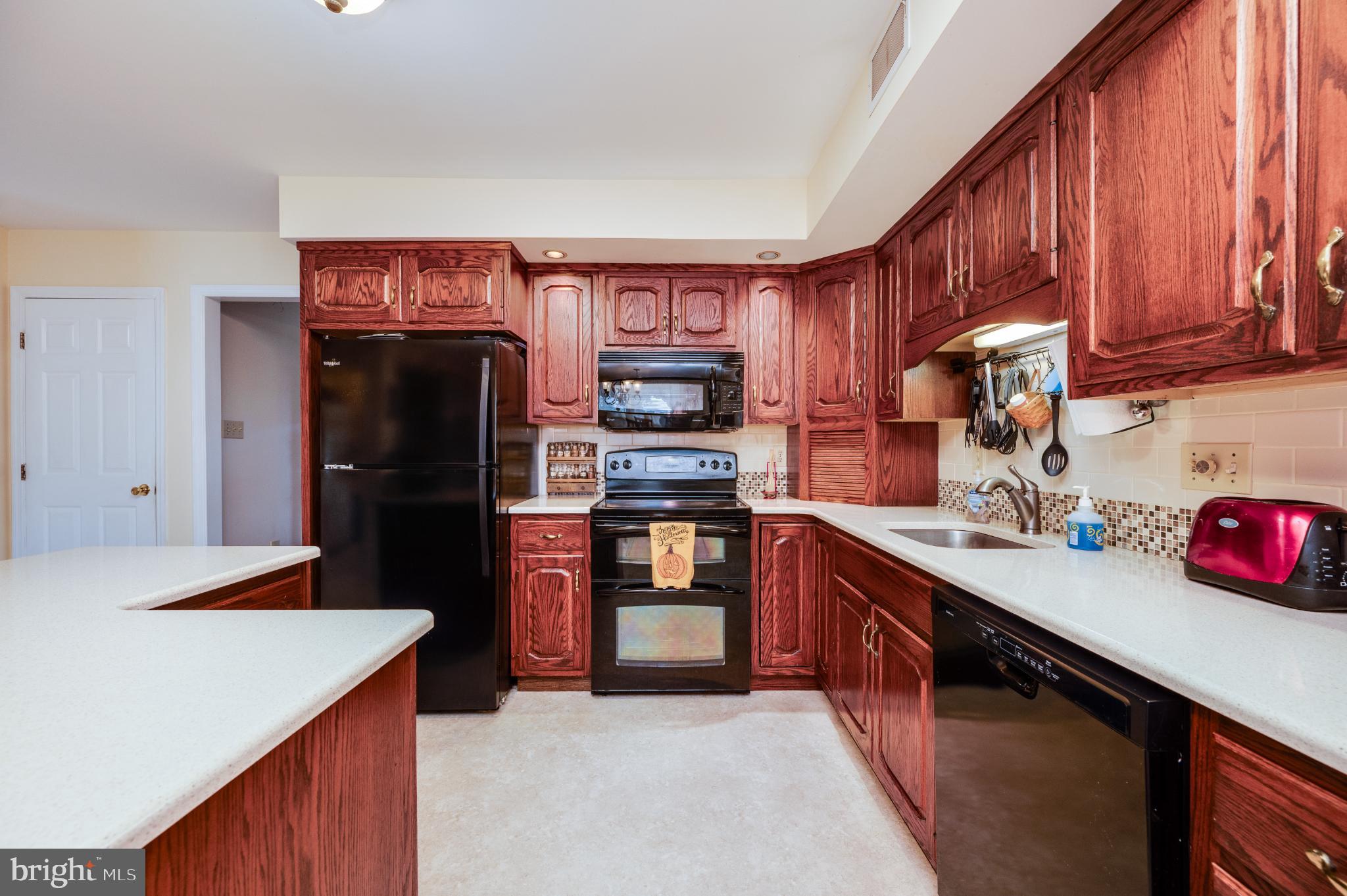 1052 Boeshore Circle Reading, PA 19605 - Photo 30 of 72 a kitchen with stainless steel appliances kitchen island granite countertop a refrigerator stove and sink