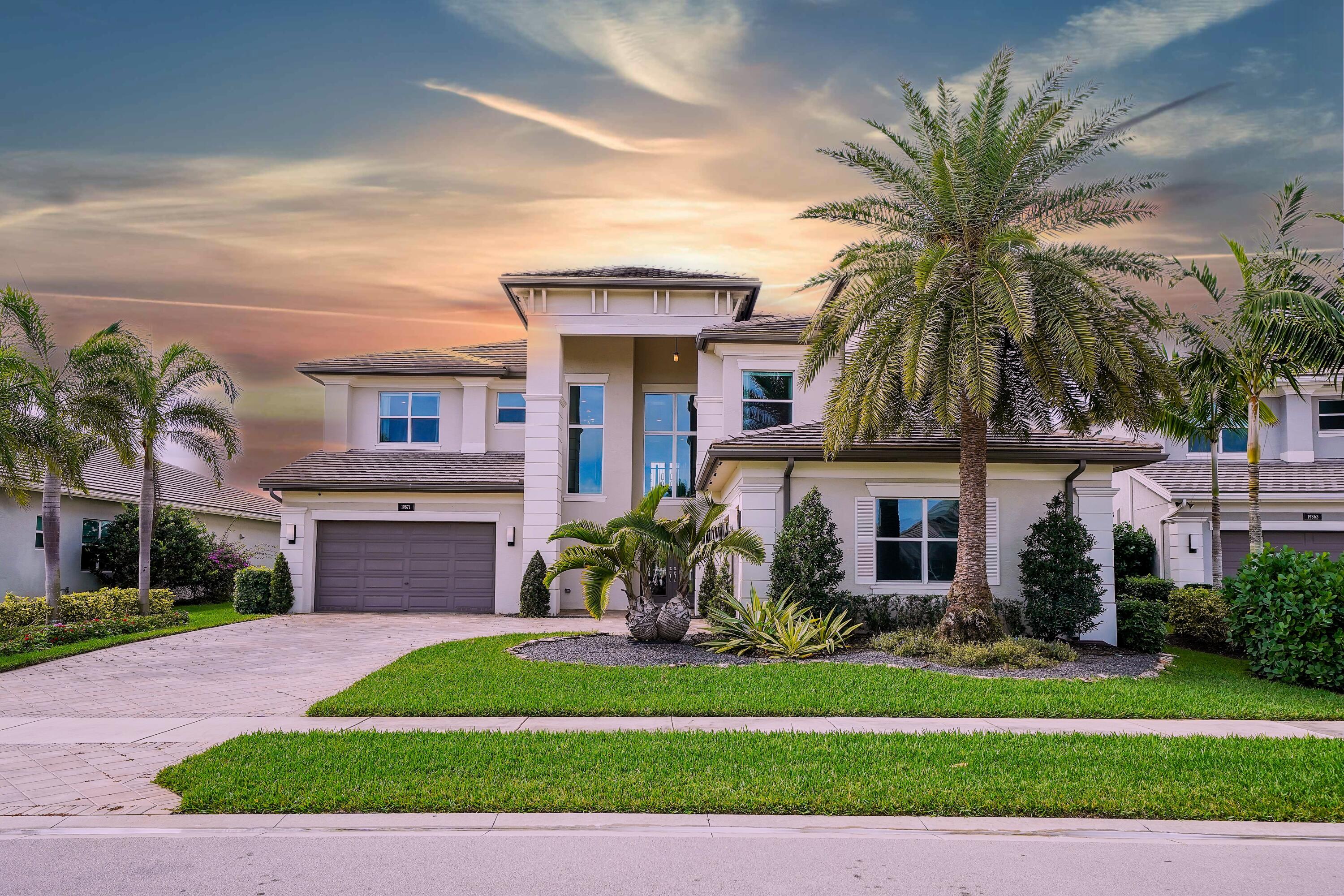 19871 Meadowside Lane Boca Raton, FL 33498 - Photo 1 of 102 a front view of a house with a yard and potted plants