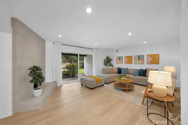 a living room with furniture potted plant and a window