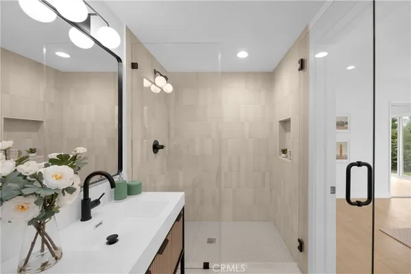 a bathroom with a tub sink and mirror