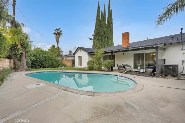 a view of outdoor kitchen and swimming pool