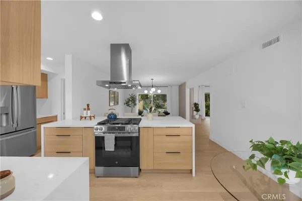 a kitchen with stainless steel appliances a stove and a refrigerator