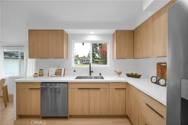 a kitchen with a sink cabinets and window