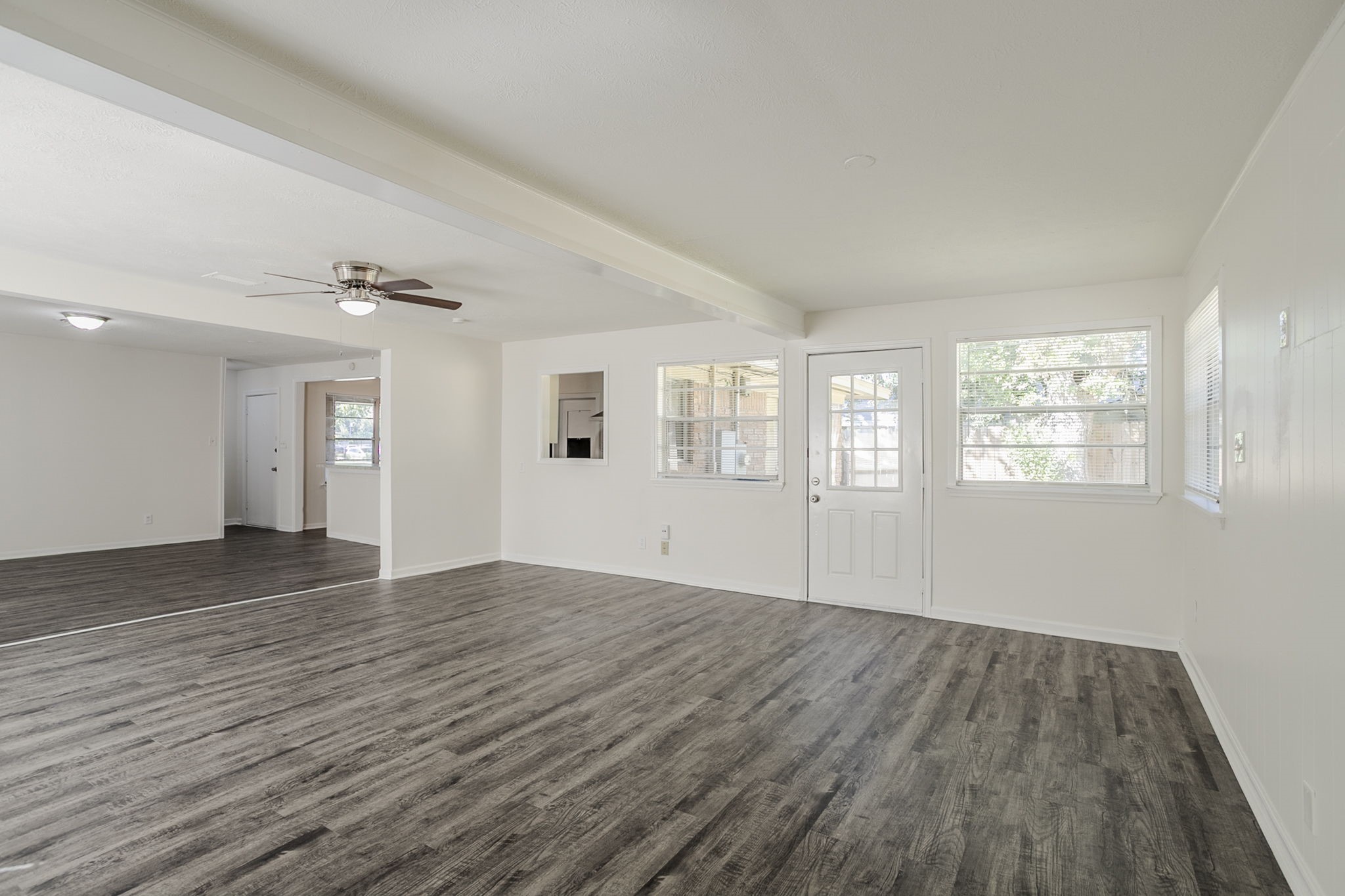 6434 Leader Street Houston, TX 77074 - Photo 19 of 46 a view of an empty room with wooden floor and a window